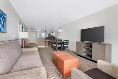a living room with a couch and a flat screen tv at Parkway International Resort in Orlando