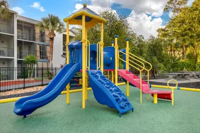 a playground with a slide in a park at Parkway International Resort in Orlando