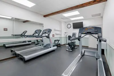 a gym with treadmills and machines in a room at Parkway International Resort in Orlando