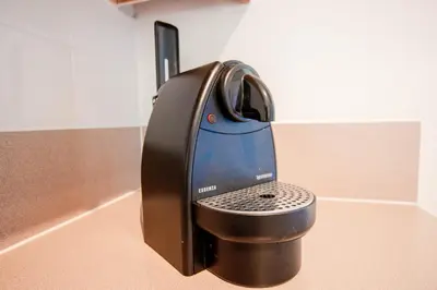 a black iron is sitting on a counter at Berkley Lake Townhomes in Kissimmee