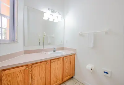 a bathroom with a sink and a mirror at Berkley Lake Townhomes in Kissimmee