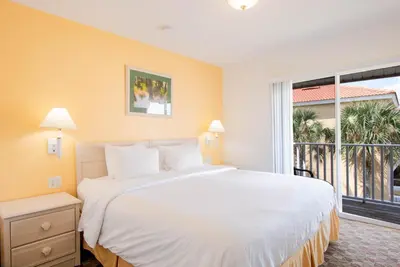 a bedroom with a large white bed and a large window at Berkley Lake Townhomes in Kissimmee