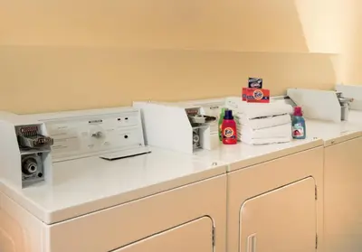 a laundry room with a washer and dryer on a counter at Parc Corniche Condominium Suites in Orlando