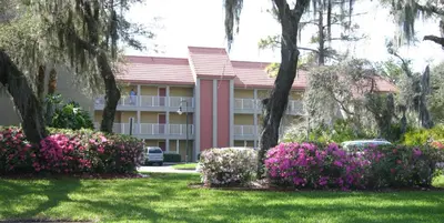 a building with pink flowers in front of it at Parc Corniche Condominium Suites in Orlando