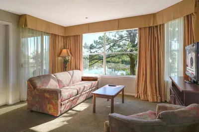 a living room with a couch and a table at Parc Corniche Condominium Suites in Orlando