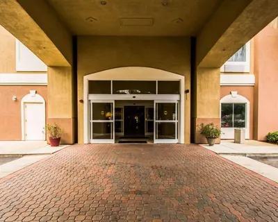 an entrance to a building with a brick driveway at Sleep Inn & Suites Orlando International Airport in Orlando