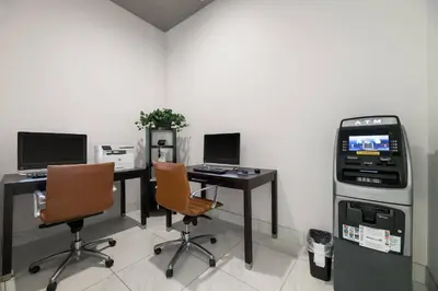 a room with two desks with two monitors and a cash register at Clarion Inn & Suites Across From Universal Orlando Resort in Orlando