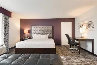 a hotel room with a bed and a desk at Clarion Inn & Suites Across From Universal Orlando Resort in Orlando