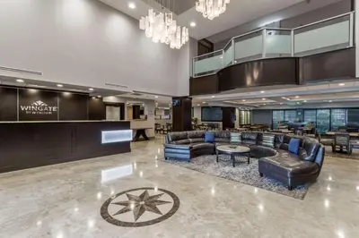 a lobby with couches and tables and a bar at Wingate by Wyndham, Universal Studios - Free Theme Park Shuttle in Orlando