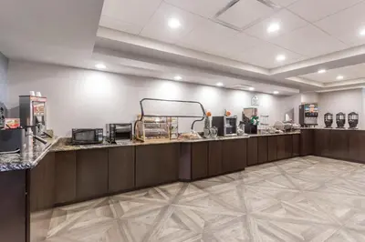 a restaurant with a counter in a room at Wingate by Wyndham, Universal Studios - Free Theme Park Shuttle in Orlando
