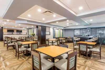 a dining room with tables and chairs at Wingate by Wyndham, Universal Studios - Free Theme Park Shuttle in Orlando