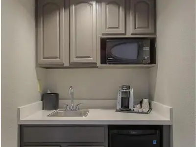 a kitchen with a sink and a microwave at Holiday Inn & Suites Orlando SW - Celebration Area by IHG in Orlando
