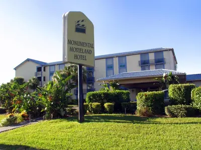 a sign in the grass in front of a building at Monumental Movieland Hotel in Orlando