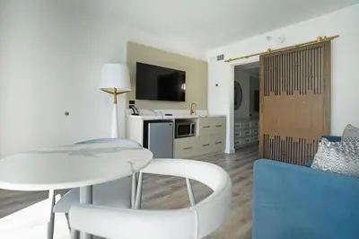 a living room with a table and a couch at DASKK Orlando Hotel near Universal Blvd, an Ascend Collection Hotel in Orlando