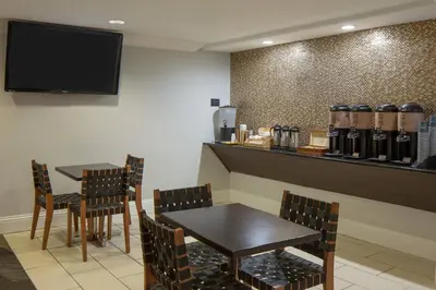 a restaurant with two tables and chairs and a bar at Four Points by Sheraton Orlando International Drive in Orlando