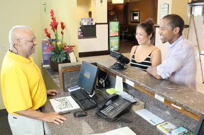 a man and a woman standing at a cash register at Rosen Inn at Pointe Orlando in Orlando