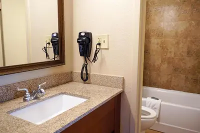 a bathroom with a sink and a phone on the wall at Rosen Inn at Pointe Orlando in Orlando
