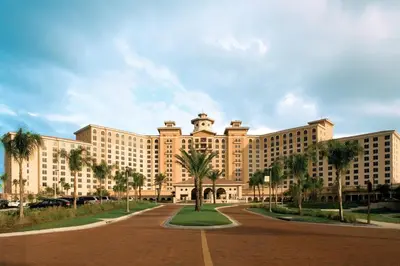 a large building with palm trees in front of it at Rosen Shingle Creek Universal Blvd in Orlando