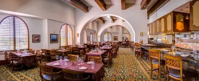 a restaurant with tables and chairs in a room at Rosen Shingle Creek Universal Blvd in Orlando