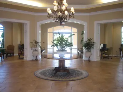 a large lobby with a table and a large mirror at Monumental Hotel Orlando in Orlando