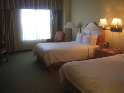 a hotel room with two beds and a window at Monumental Hotel Orlando in Orlando