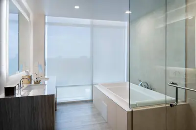 a bathroom with a bath tub and a sink at JW Marriott Orlando Bonnet Creek Resort & Spa in Orlando