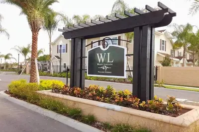 a sign for a villa with palm trees at Amazing private townhouse in gated community with amenities Great location, near Disney! in Kissimmee
