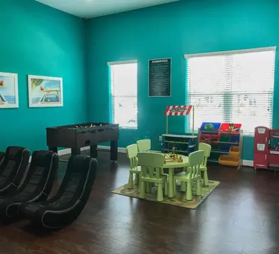 a play room with a ping pong table and chairs at 3 Bedroom townhouse fits 8, 10' to Disney parks! in Kissimmee
