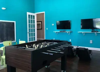 a blue room with a large pool table at 3 Bedroom townhouse fits 8, 10' to Disney parks! in Kissimmee
