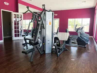 a gym with several tread machines in a room at 3 Bedroom townhouse fits 8, 10' to Disney parks! in Kissimmee