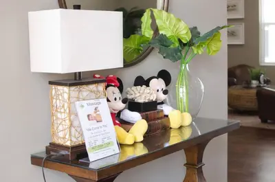 a table with stuffed animals and a lamp and a vase at 3 Bedroom townhouse in luxury Resort, sleeps 8, 10 min to Disney! in Kissimmee