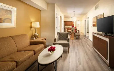 a living room with a couch and a tv at Floridays Orlando Two & Three Bed Rooms Condo Resort in Orlando