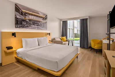 a hotel room with a bed and a living room at B&B HOTEL Orlando International Drive near Universal - Newly Renovated! in Orlando