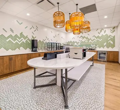 a kitchen with a white table and a counter top at B&B HOTEL Orlando International Drive near Universal - Newly Renovated! in Orlando