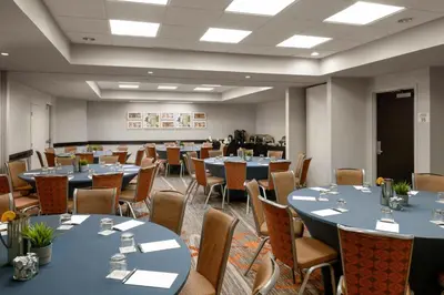 a conference room with tables and chairs in it at Sheraton Suites Orlando Airport Hotel in Orlando