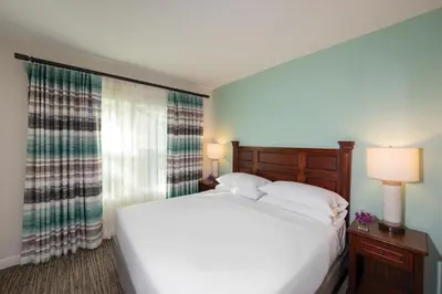 a bedroom with a large white bed and a window at Sheraton Vistana Villages Resort Villas, I-Drive Orlando in Orlando