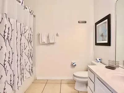 a bathroom with a toilet and a shower curtain at Vista Cay at Epic Universe - Luxury 4 bedroom condo in Orlando