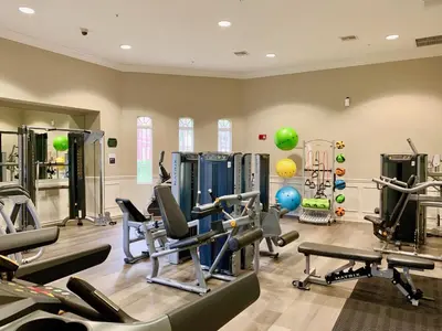 a gym with tread machines and exercise equipment in a room at Vista Cay at Epic Universe - Luxury Lakeview 4 bedroom condo in Orlando