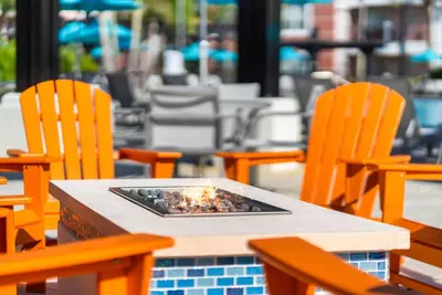 a table with chairs and a fire pit on it at Vista Cay at Epic Universe - Standard 3 bedroom condo in Orlando