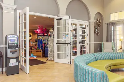 a clothing store with a couch and a ticket machine at Vista Cay at Epic Universe - Standard 3 bedroom condo in Orlando