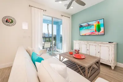 a living room with a white couch and a table at Blue Oasis Cottage With Private Pool Near Disney And Margaritaville Resort & Island H20 Access - 7968Sh in Orlando