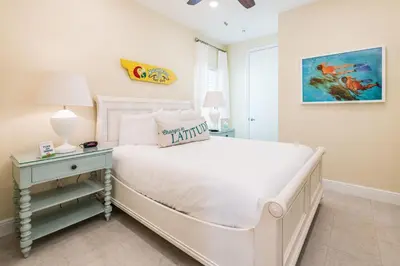 a bedroom with a white bed and a night stand with a lamp at Smooth Sailing Cottage With Private Pool Near Disney And Margaritaville Resort & Island H20 Waterpark Access - 7992Sh in Orlando