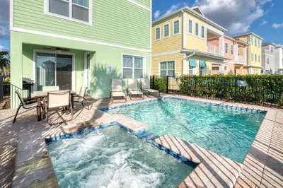 a swimming pool in front of a house at Smooth Sailing Cottage With Private Pool Near Disney And Margaritaville Resort & Island H20 Waterpark Access - 7992Sh in Orlando
