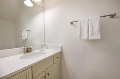 a bathroom with a sink and a mirror and towels at Premium Cottage With Private Hot Tub Near Disney Margaritaville Resort & Island H2O Access - 3025La in Orlando