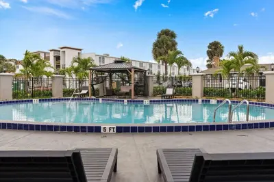 a swimming pool with a gazebo in a resort at Super 8 by Wyndham Kissimmee-Orlando in Kissimmee
