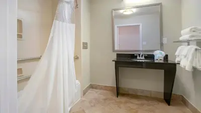 a bathroom with a shower with a sink and a mirror at Galleria Palms Orlando - Free Theme Park Shuttles in Orlando