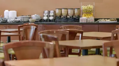 a restaurant with tables and chairs and a counter at Galleria Palms Orlando - Free Theme Park Shuttles in Orlando