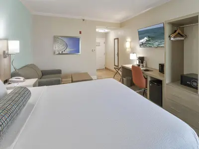 a hotel room with a bed and a desk at Galleria Palms Orlando - Free Theme Park Shuttles in Orlando