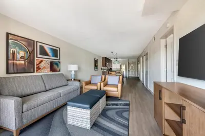 a living room with a couch and a flat screen tv at Orbit One Vacation Villas in Orlando