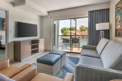 a living room with a couch and a television at Orbit One Vacation Villas in Orlando